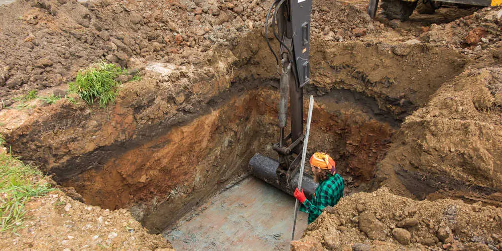 Excavation exposing a septic system for repair